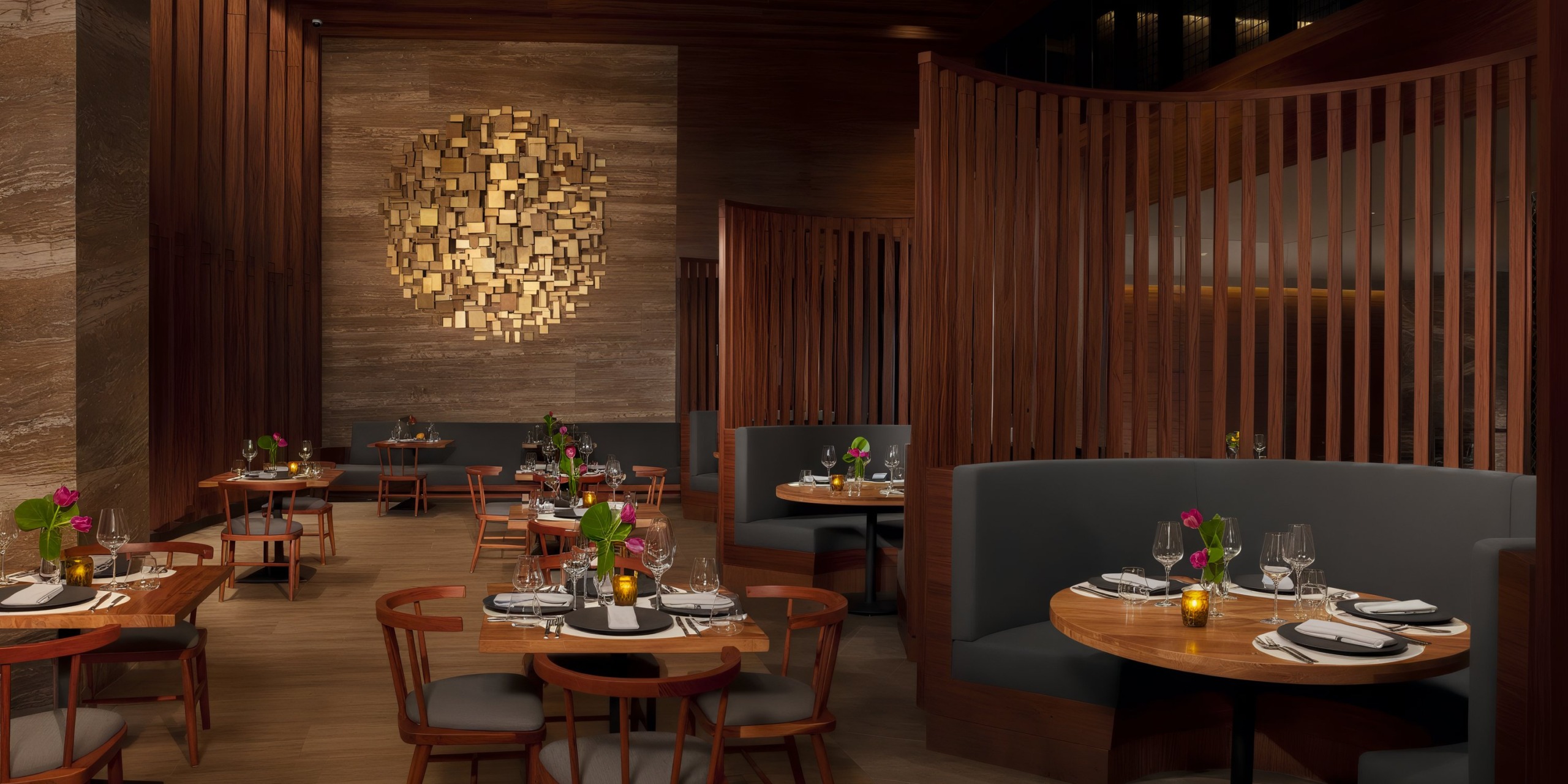 The interior of Secrets Bahia Mita features a contemporary design with wooden accents, round tables adorned with plates and glasses, and wall art displayed on a textured wall.
