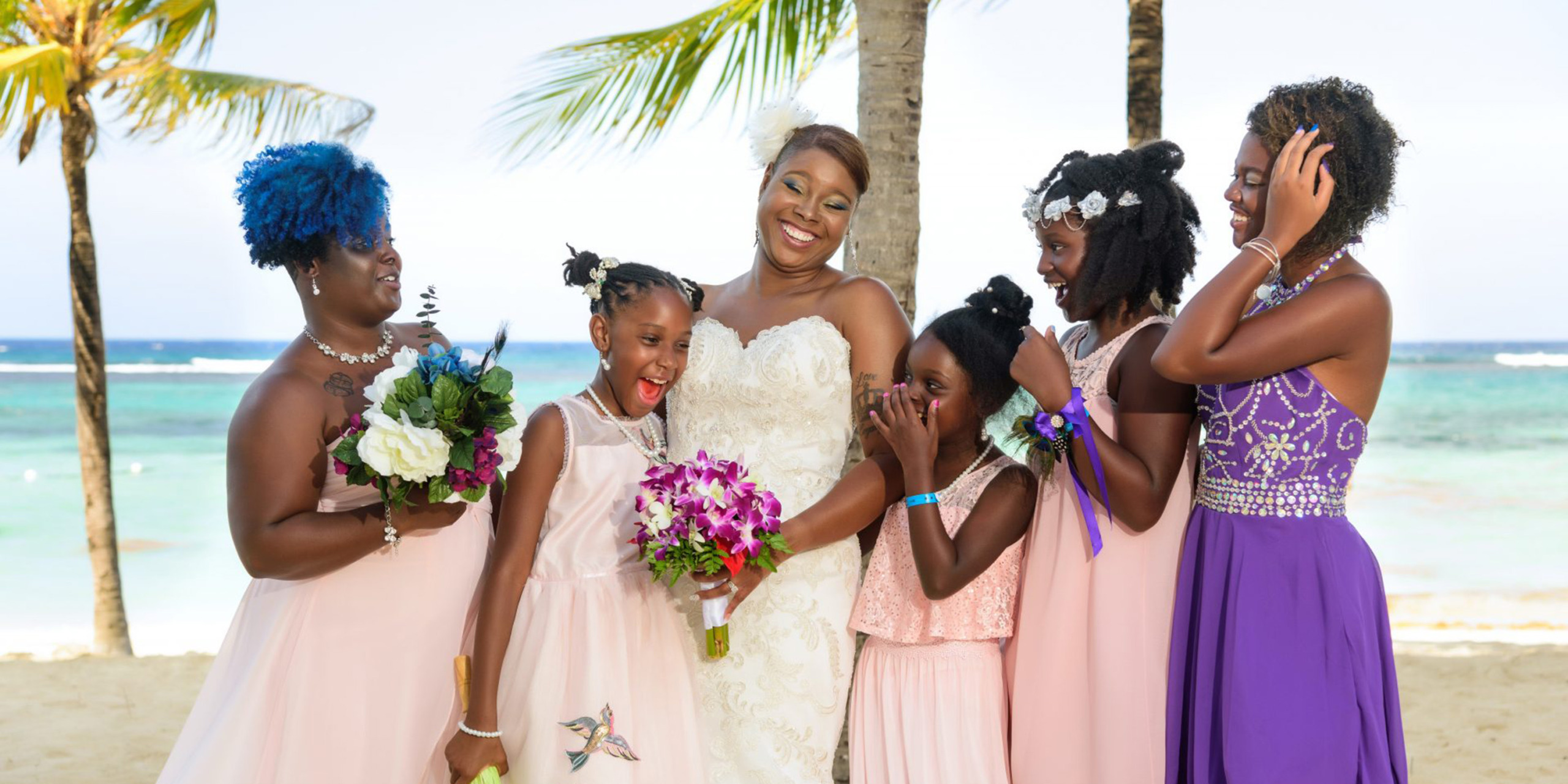 Tonya poses with her girls and her friends and family at the Destify featured destination Tonya and Omar wedding
