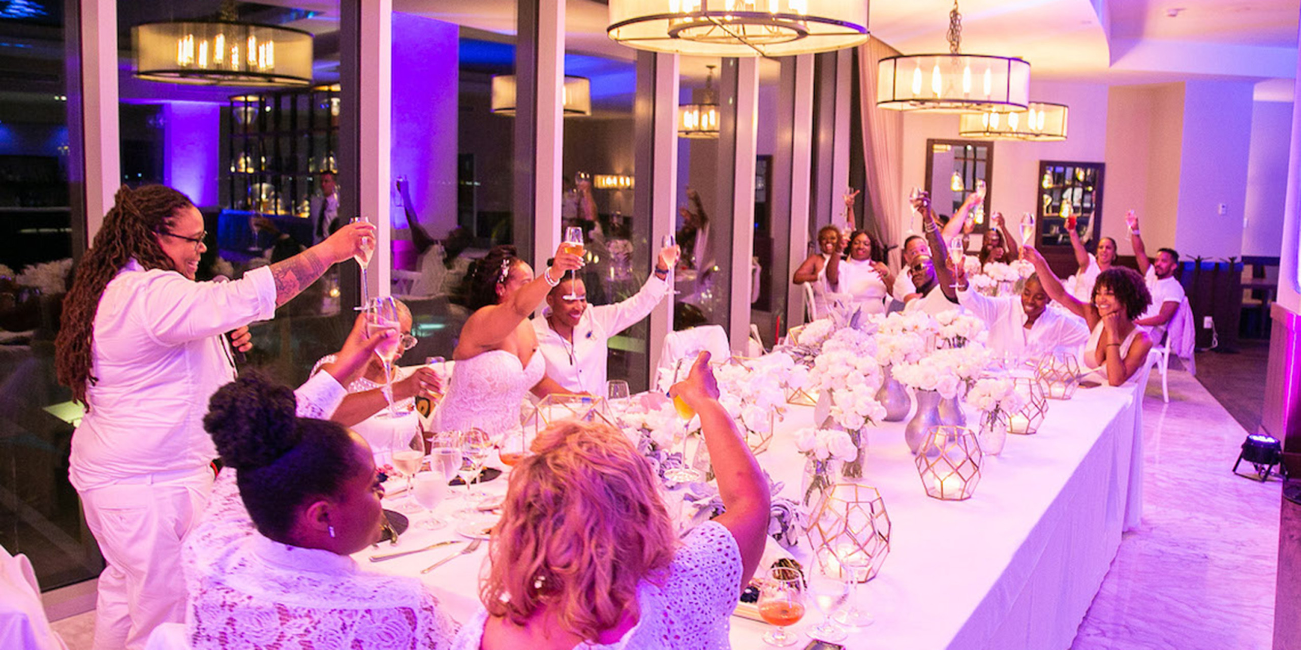 All of the guests of the Tramaine and Shannon toast the bride and groom at the wedding reception