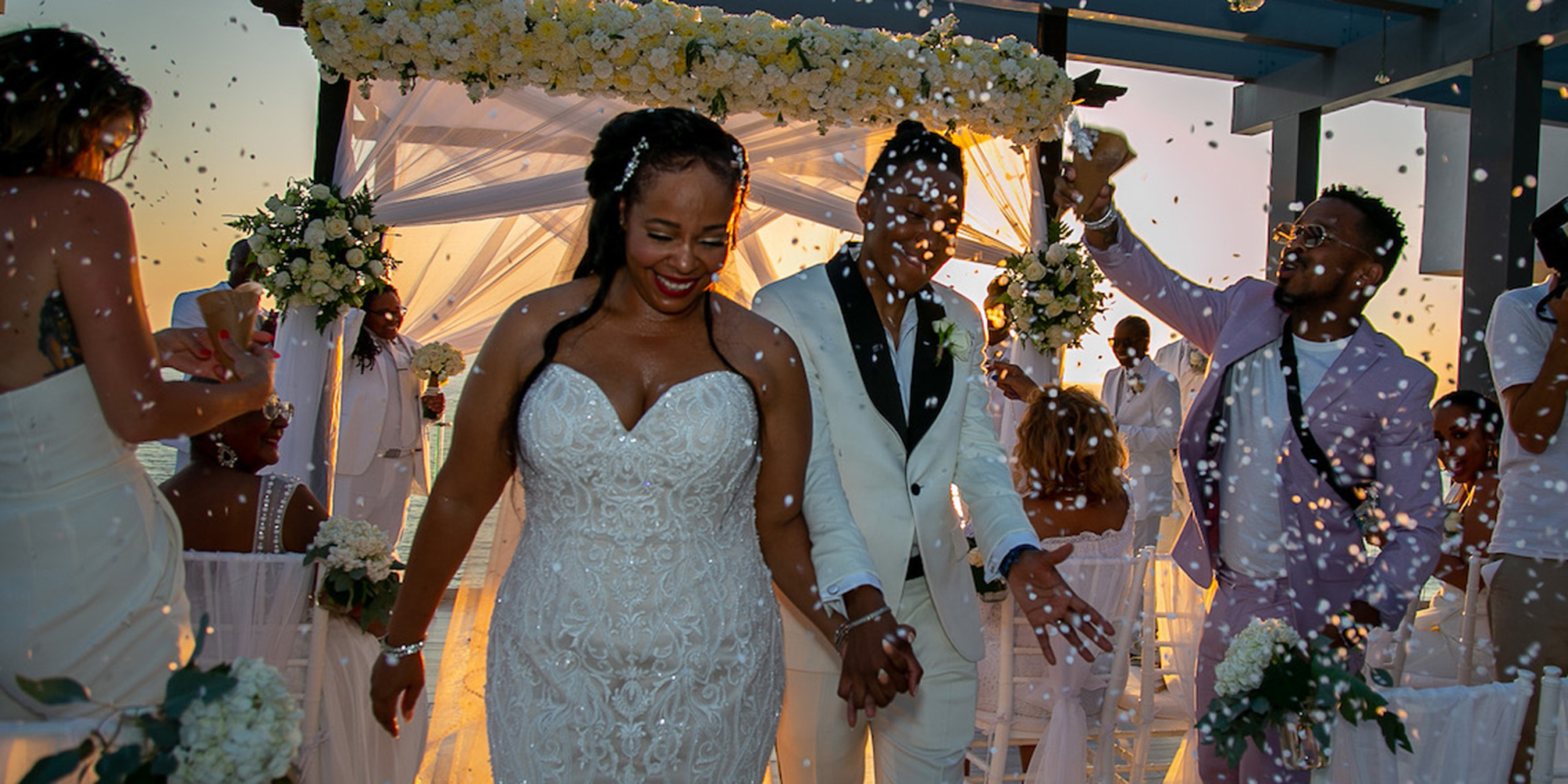 After being wed, Tramaine and Shannon walk back down the aisle as their friends throw glitter and confetti