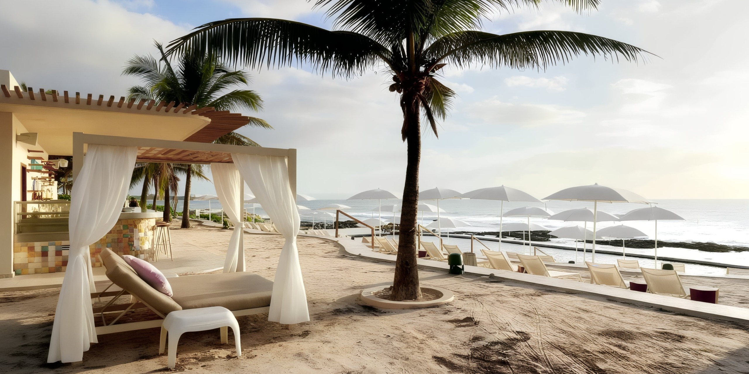 TRS Yucatan offers a picturesque beach scene with a pristine white cabana and comfortable lounge chairs positioned under palm trees, facing the ocean. Rows of white umbrellas are neatly arranged along the sandy shore for your ultimate relaxation.