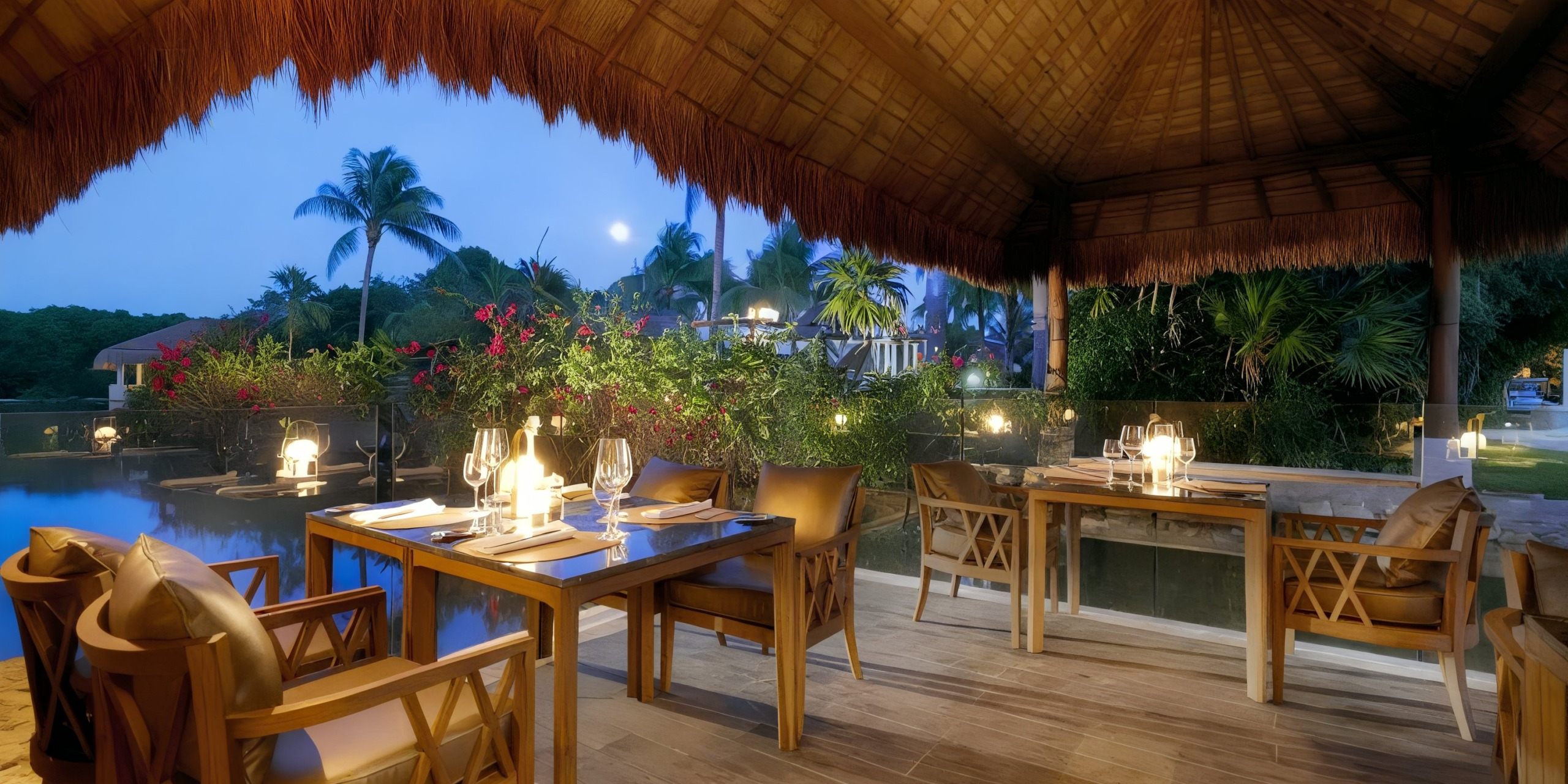 Enjoy a cozy dining experience in the TRS Yucatan's outdoor area, featuring wooden tables and chairs under a charming thatched roof. Surrounded by lush greenery, the space is beautifully illuminated by soft lighting as dusk falls.
