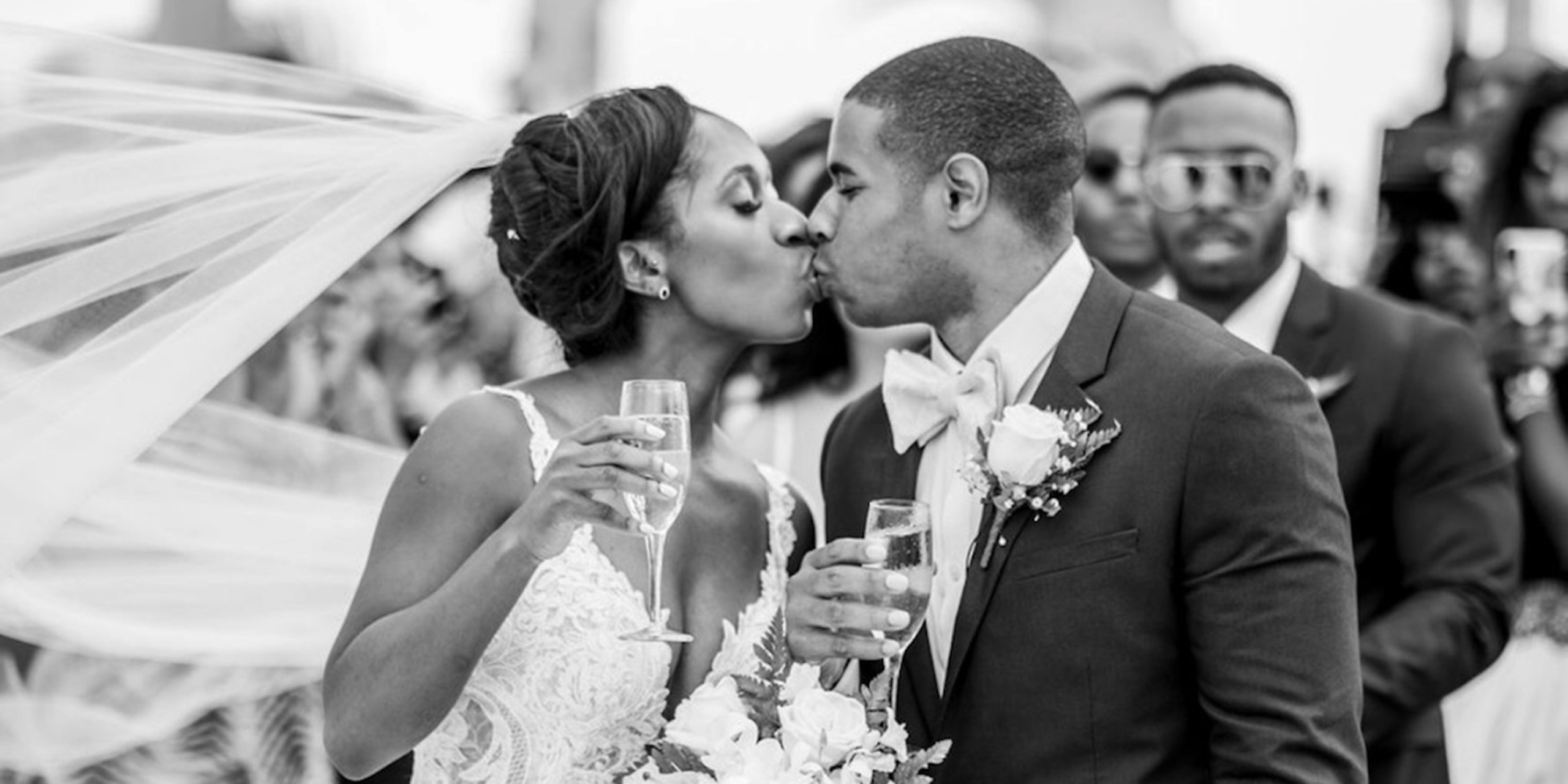 Newlyweds Wokie and James kiss at their wedding reception