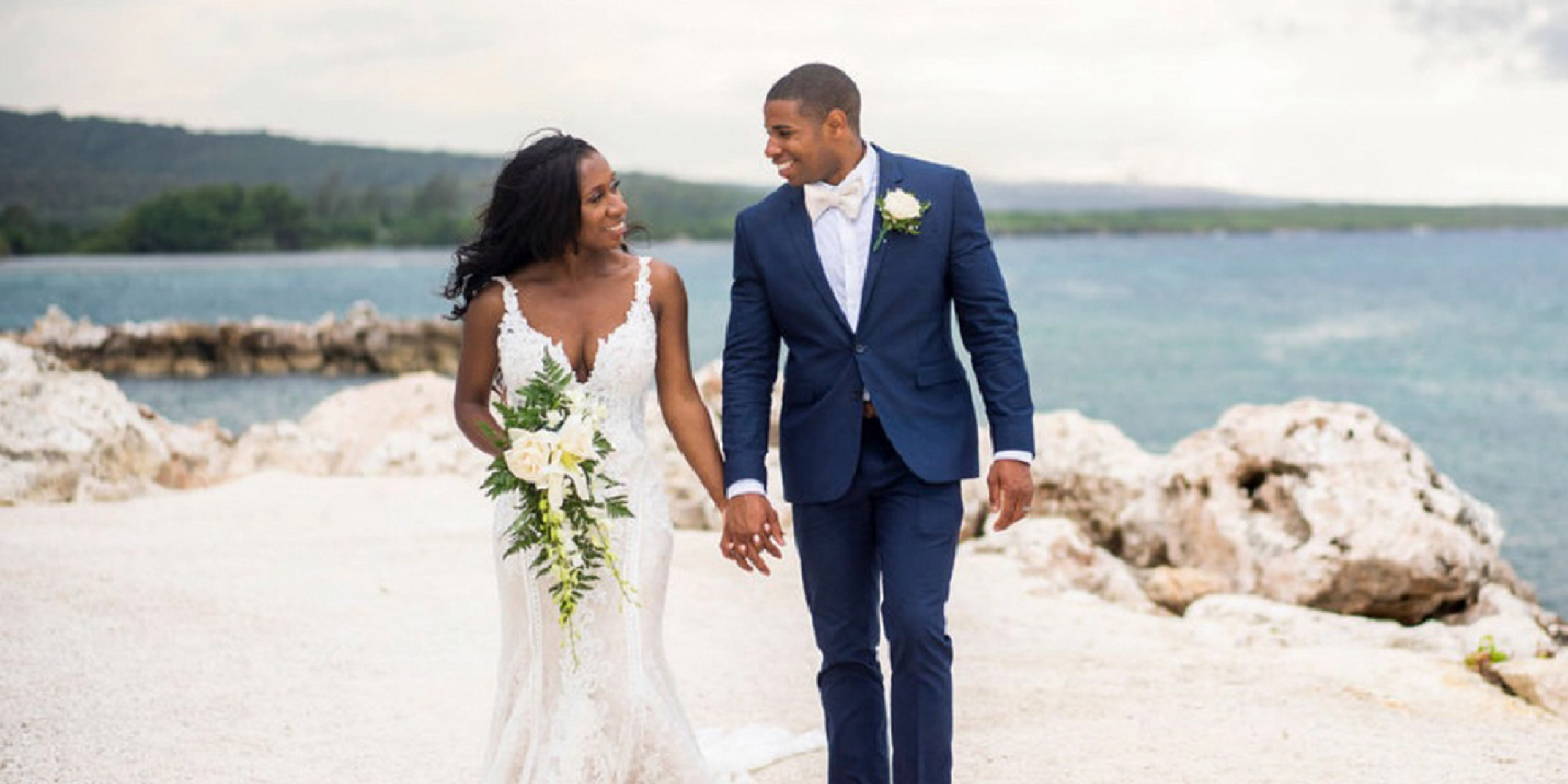 Newlyweds Brider Wokie and Groom James walk together hand-in-hand, holding hands
