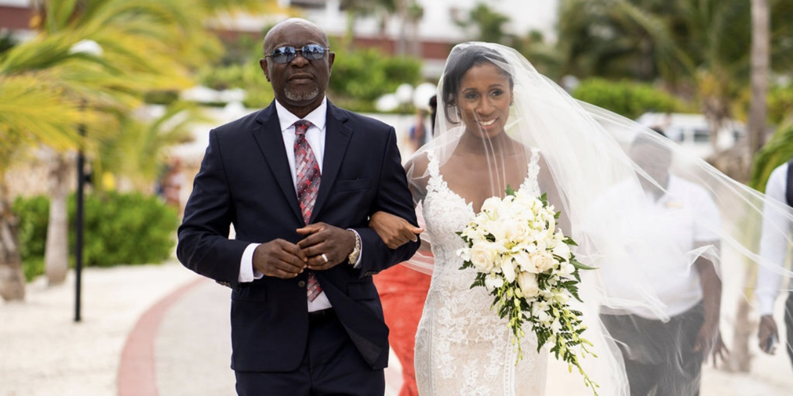 Wokie walks down the aisle with her dad at the Destify destination wedding of Wokie and James