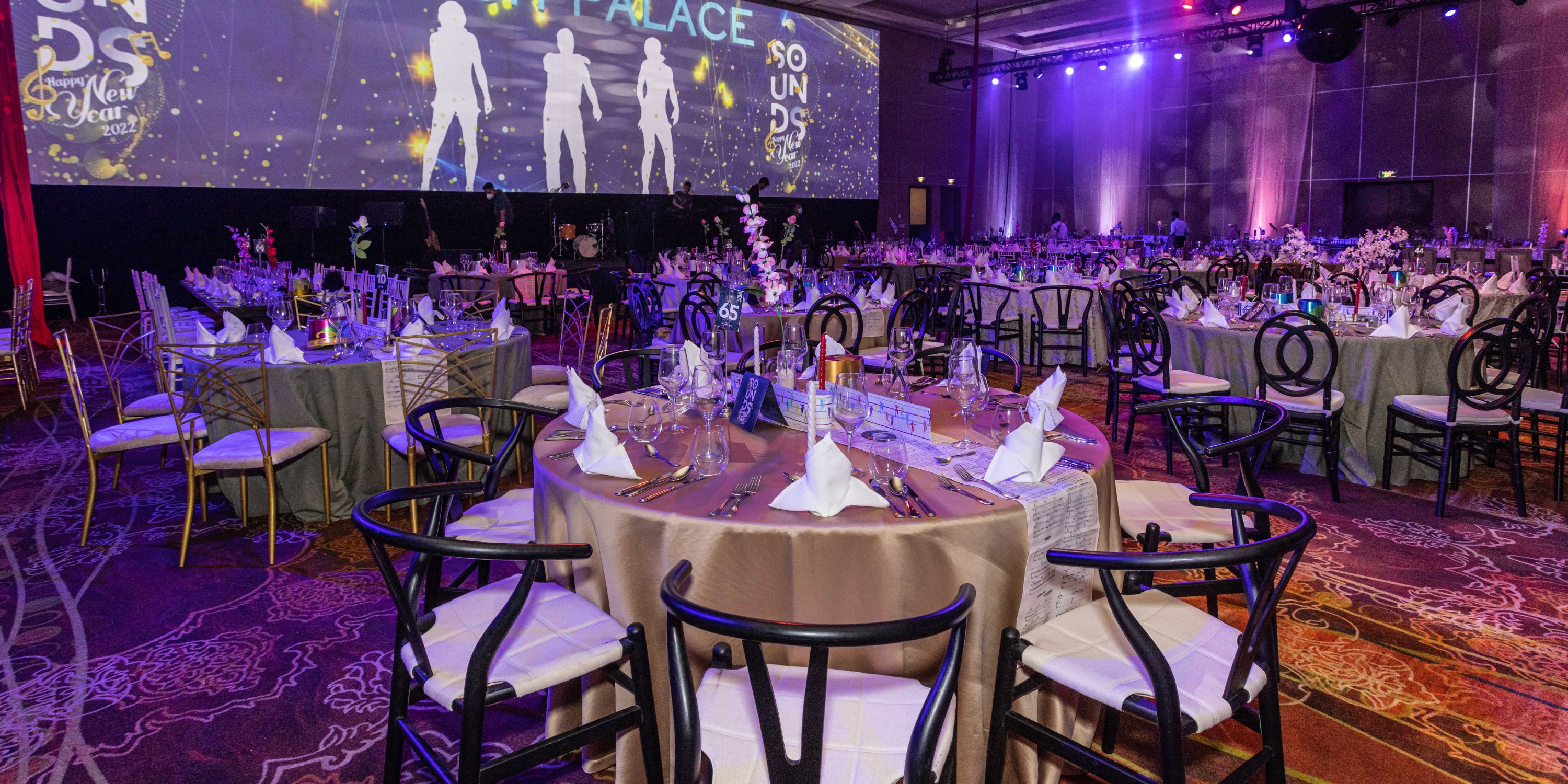Beach Palace Cancun's event hall arranged for a destination wedding with round tables and elegant decor.