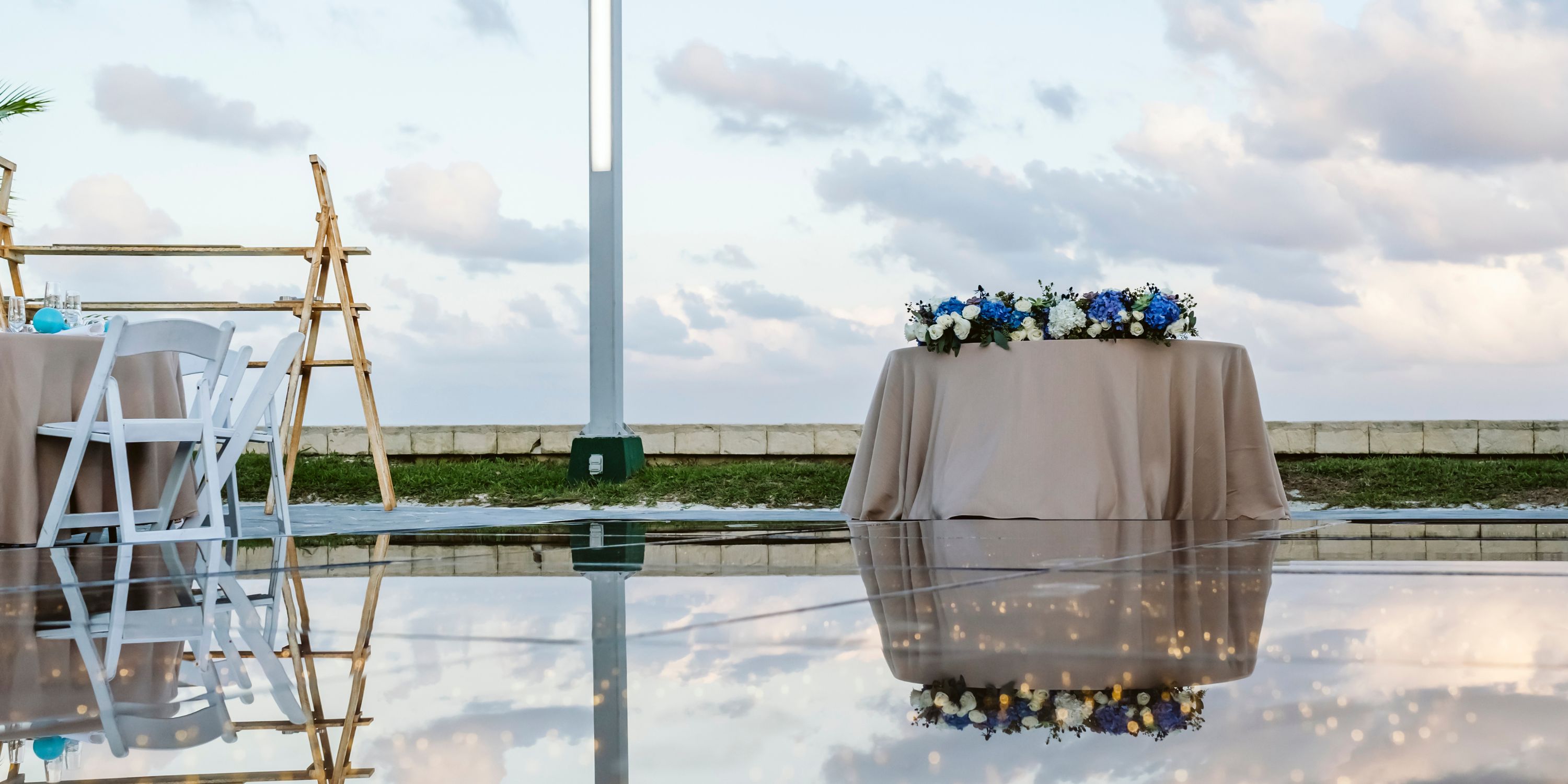 Beach Palace Cancun, a stunning destination wedding venue, reflected outdoors under a cloudy sky.