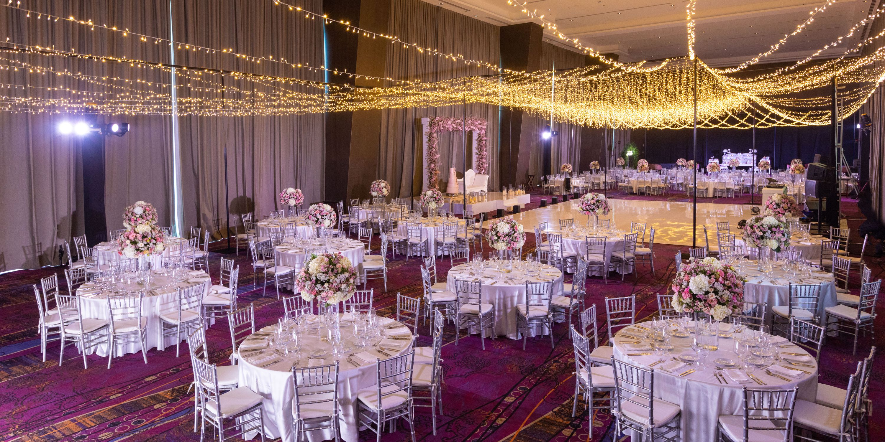 Moon Palace The Grand ballroom elegantly prepared for a destination wedding with round tables and florals.