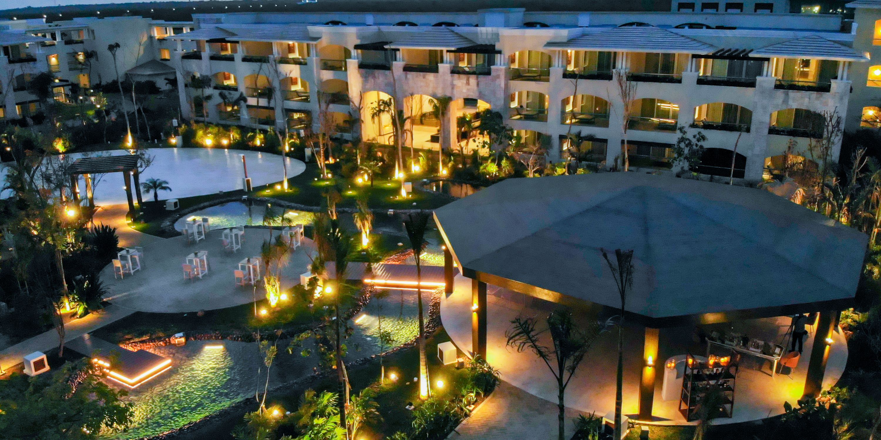 Moon Palace The Grand courtyard at night, perfect for a destination wedding with lit pool and seating.