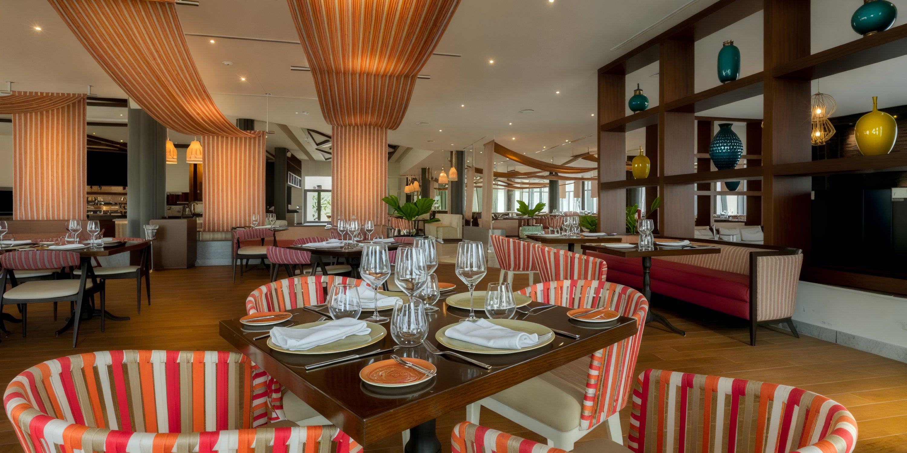 Moon Palace The Grand offers a stunning setting for destination weddings, featuring elegant interiors with striped chairs and wooden accents.