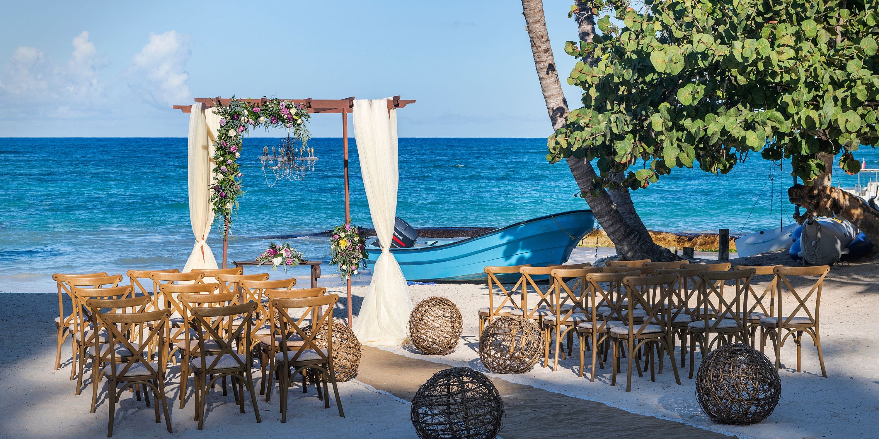Ocean Blue and Sand showcases a destination wedding setup with chairs and an arch by the ocean.