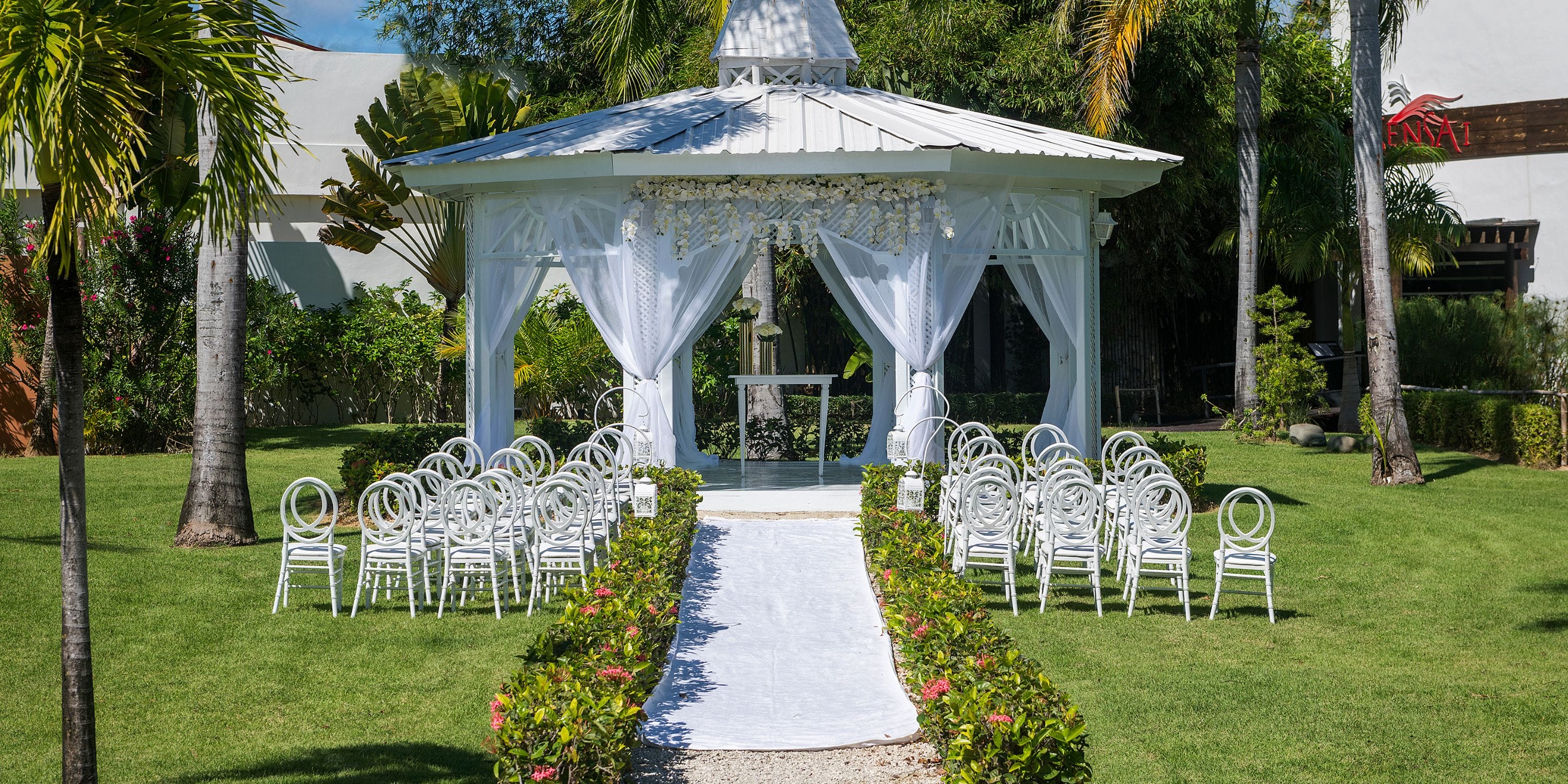 Ocean Blue and Sand gazebo prepared for a destination wedding, chairs arranged under the sunny sky.