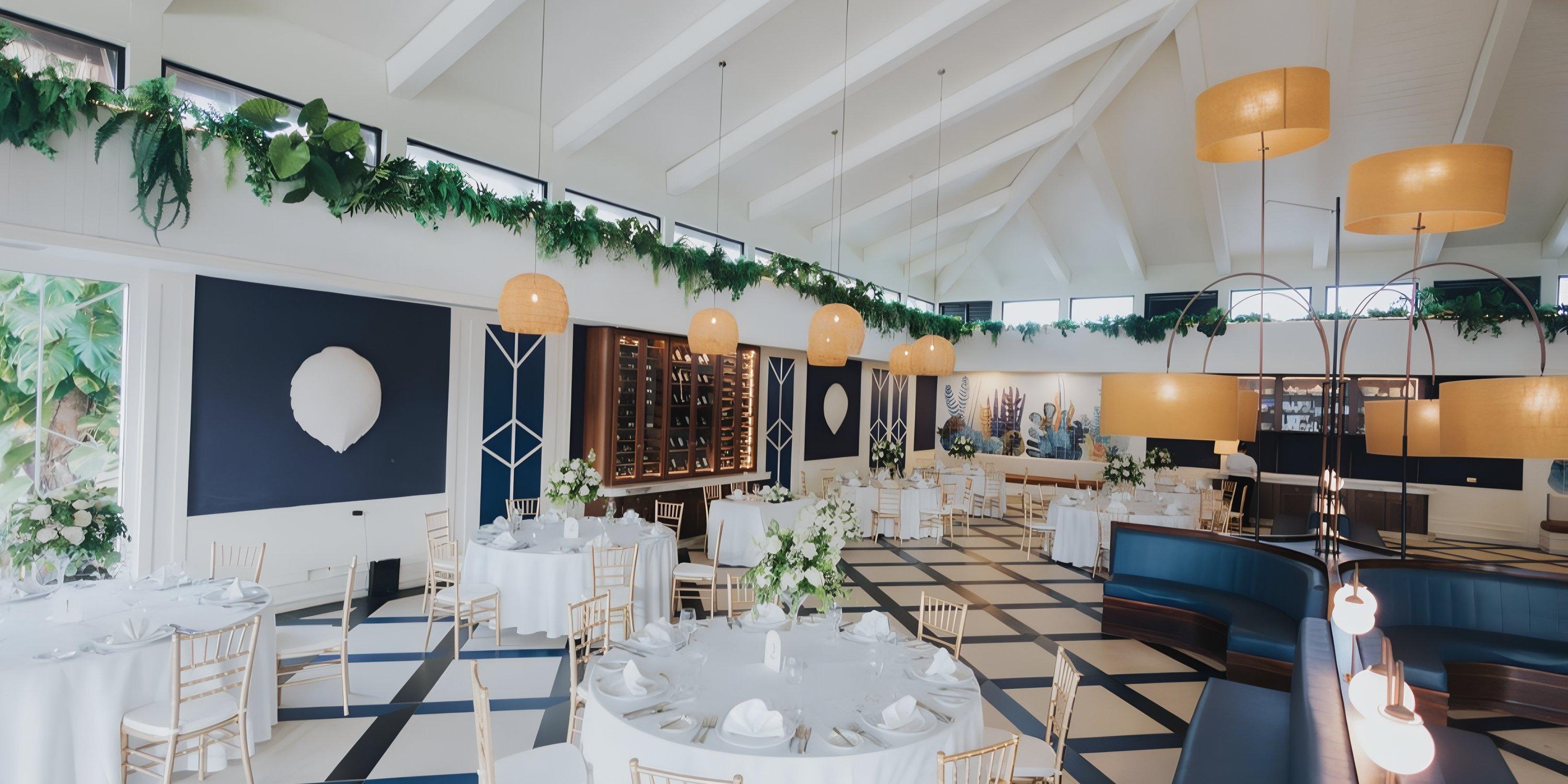 Stylish Ocean El Faro hall set for a destination wedding, with round tables, white linens, and bold floors.