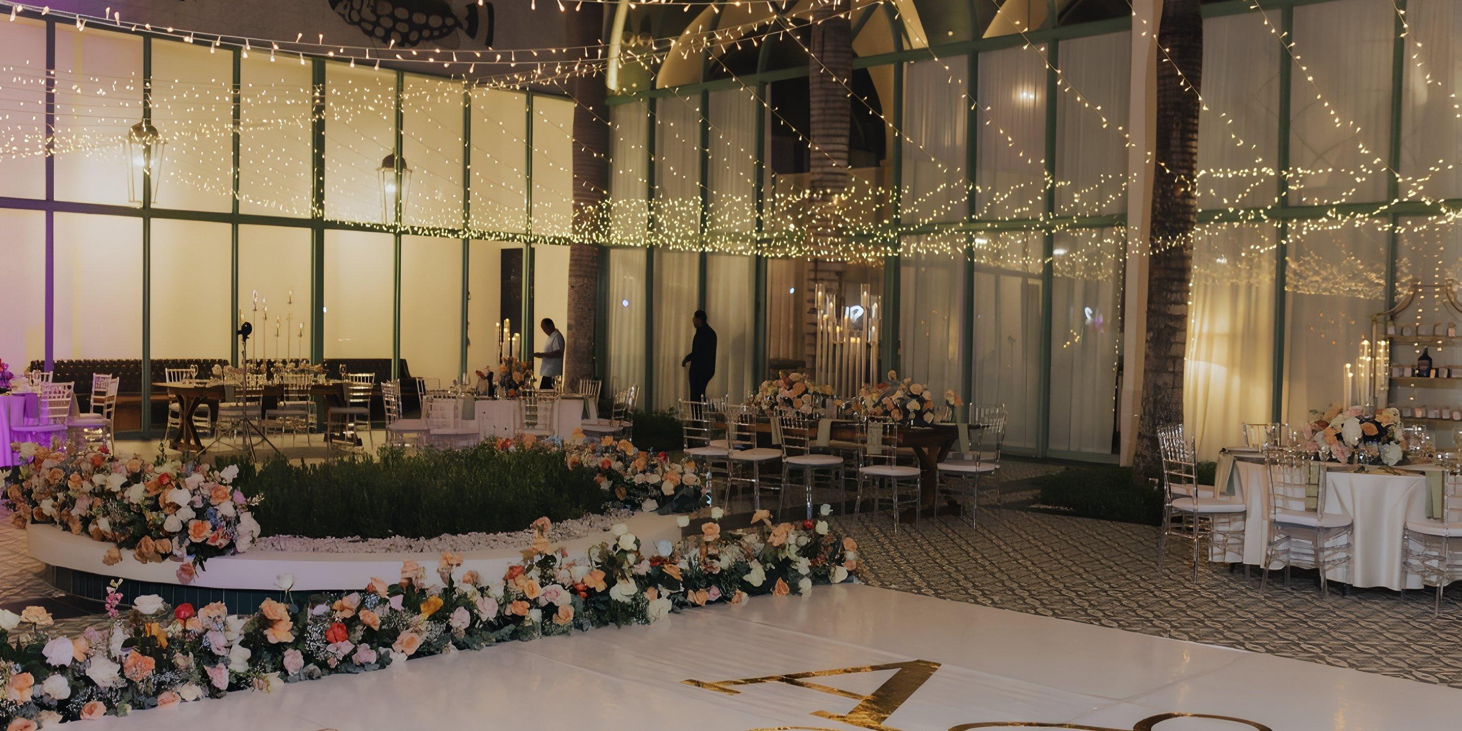 Ocean El Faro: Chic indoor wedding venue with floral décor, round tables, and glowing string lights above.