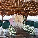 Hyatt Ziva Riviera Cancun over the water gazebo LGBTQ+ destination weddings gay couple walking down aisle
