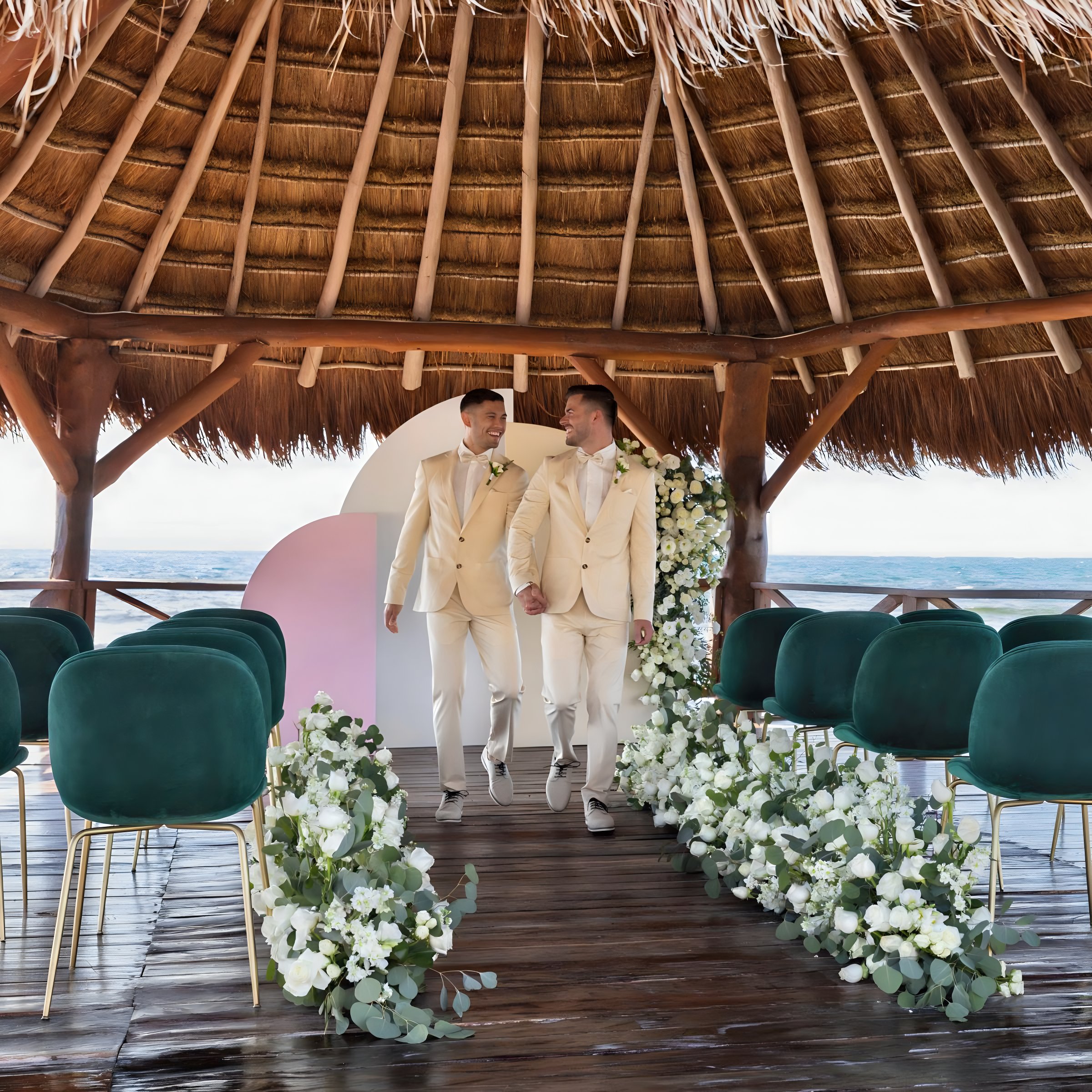 Hyatt Ziva Riviera Cancun over the water gazebo LGBTQ+ destination weddings gay couple walking down aisle