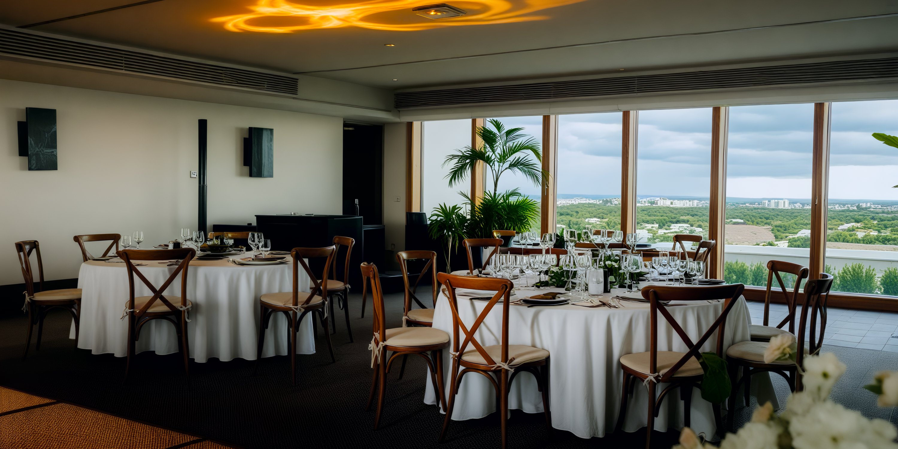The elegant dining room at Secrets Moxche Playa del Carmen, featuring round tables and scenic views, makes for the perfect destination wedding venue.