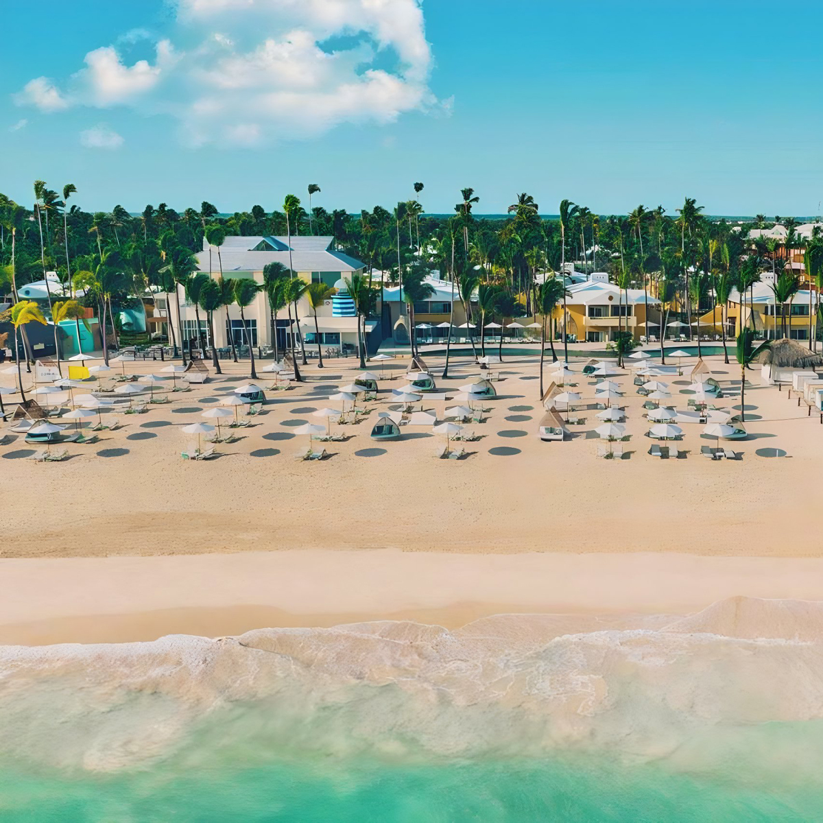 An aerial view of the Coral Level at Iberostar Selection Bavaro setup for a wedding with lounge chairs and umbrellas.