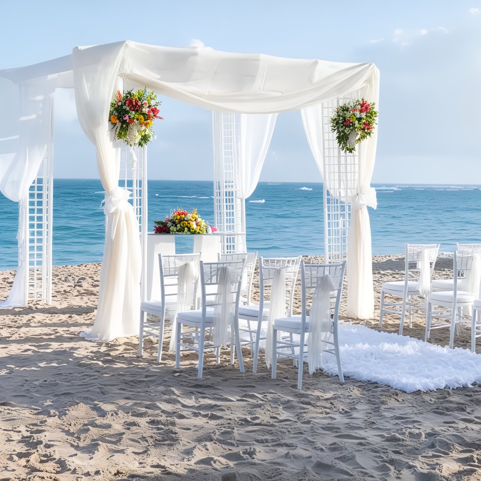 A destination wedding setup featuring white chairs and beautiful floral arrangements, all set against a stunning ocean backdrop.