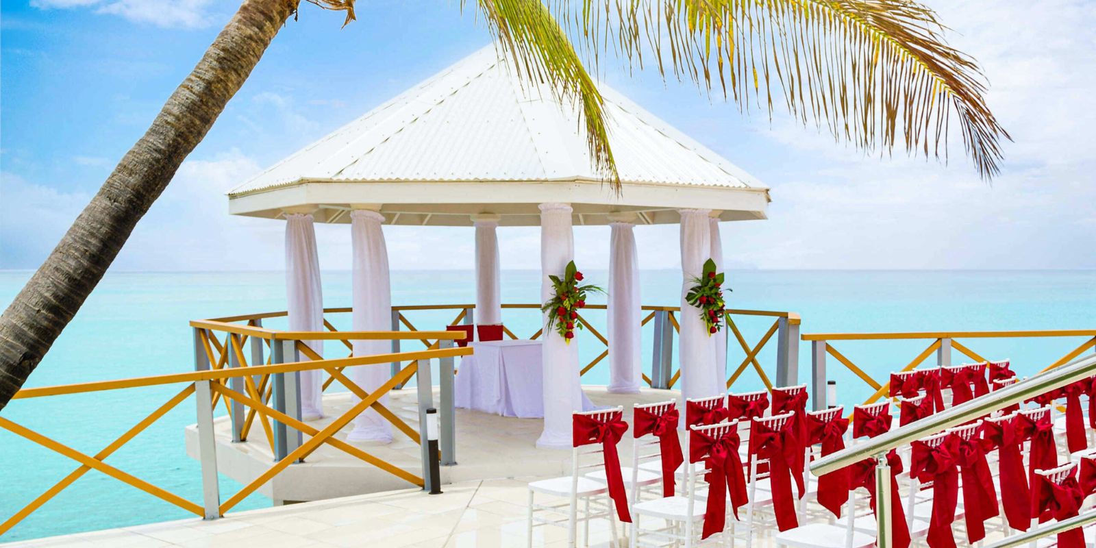A wedding Sonesta Maho Beach Resort set up for a ceremony on the beach.