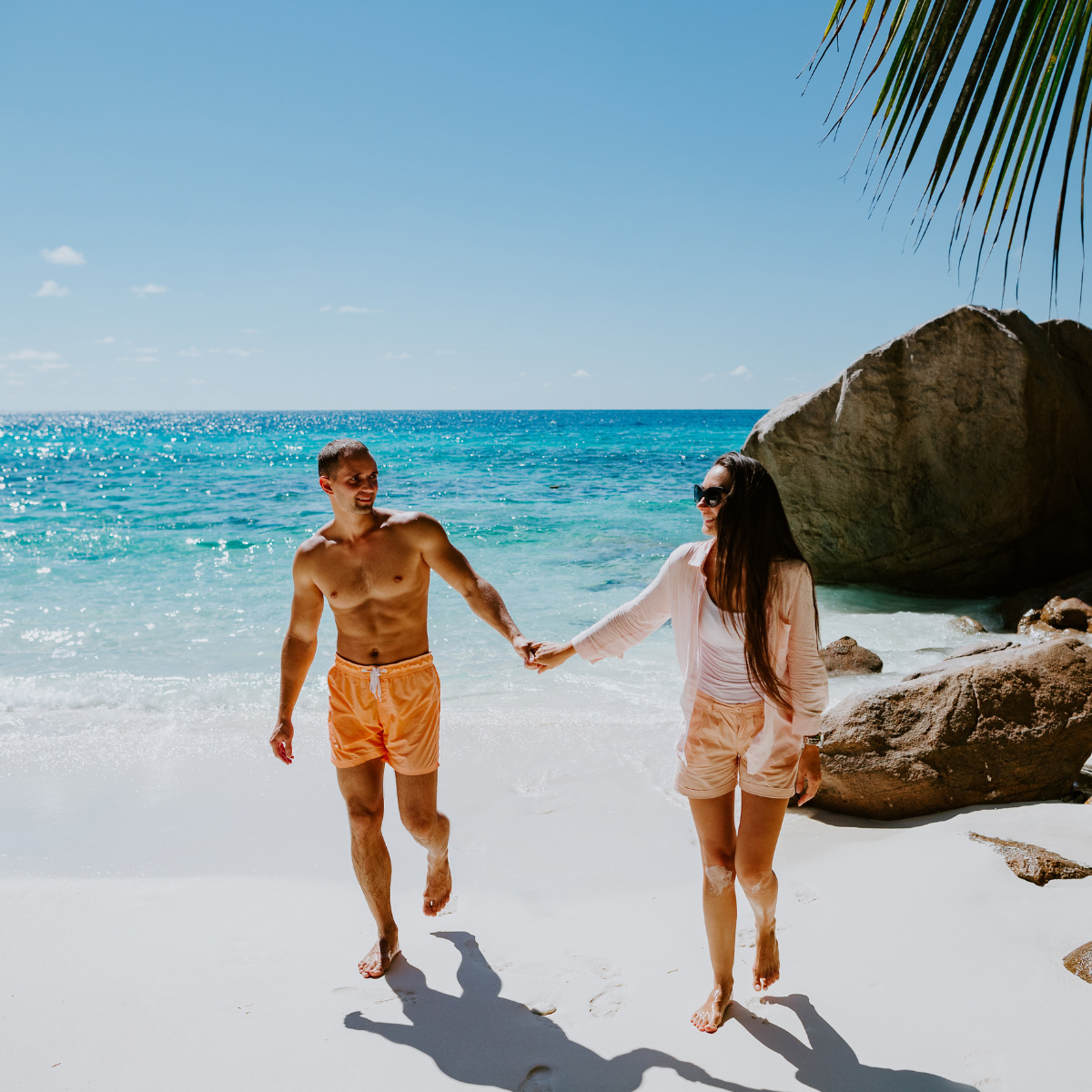 Couple on a beach during their favorite destination wedding season