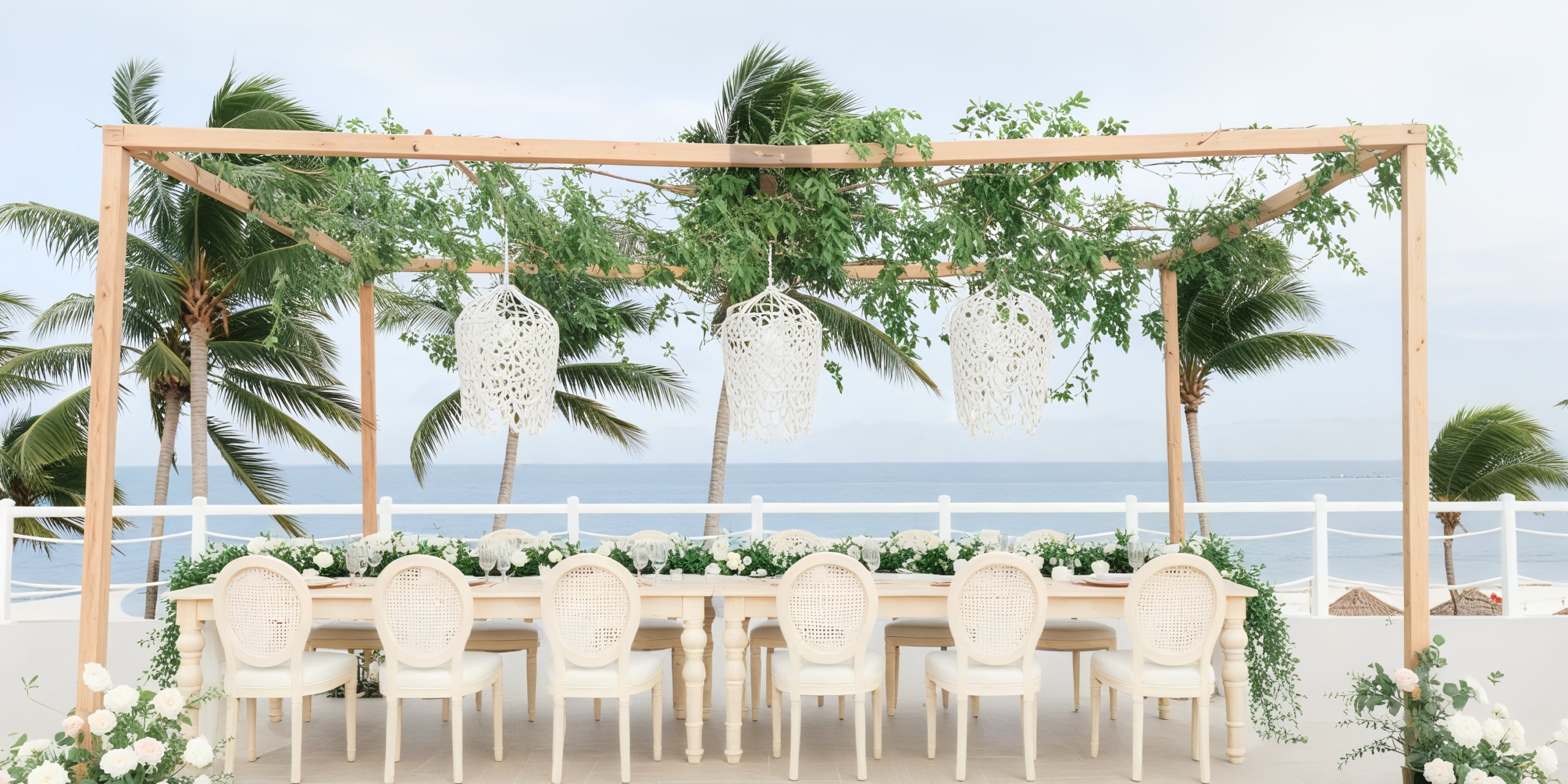 Experience a destination wedding at Hyatt Zilara Riviera Maya, where you can dine outdoors, surrounded by elegant white chairs and a picturesque pergola, all while enjoying breathtaking ocean views.