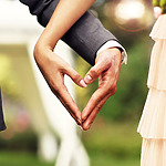 A bride and groom creating a heart shape with their hands at a Mexico wedding.