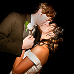 A couple embraces and kisses after their destination wedding