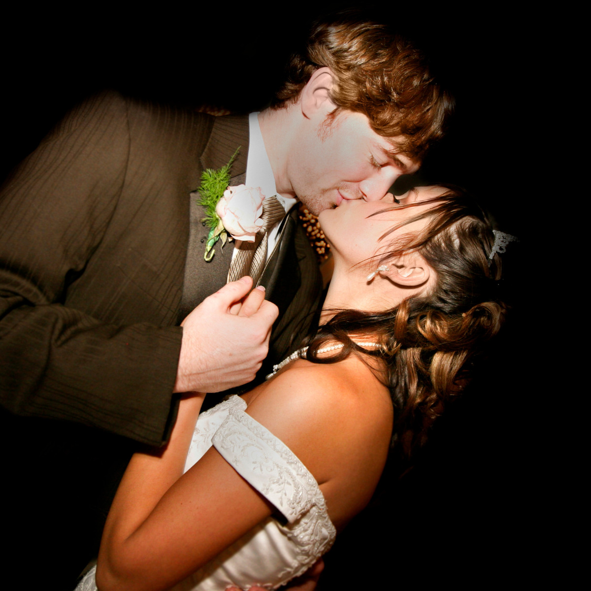 A couple embraces and kisses after their destination wedding