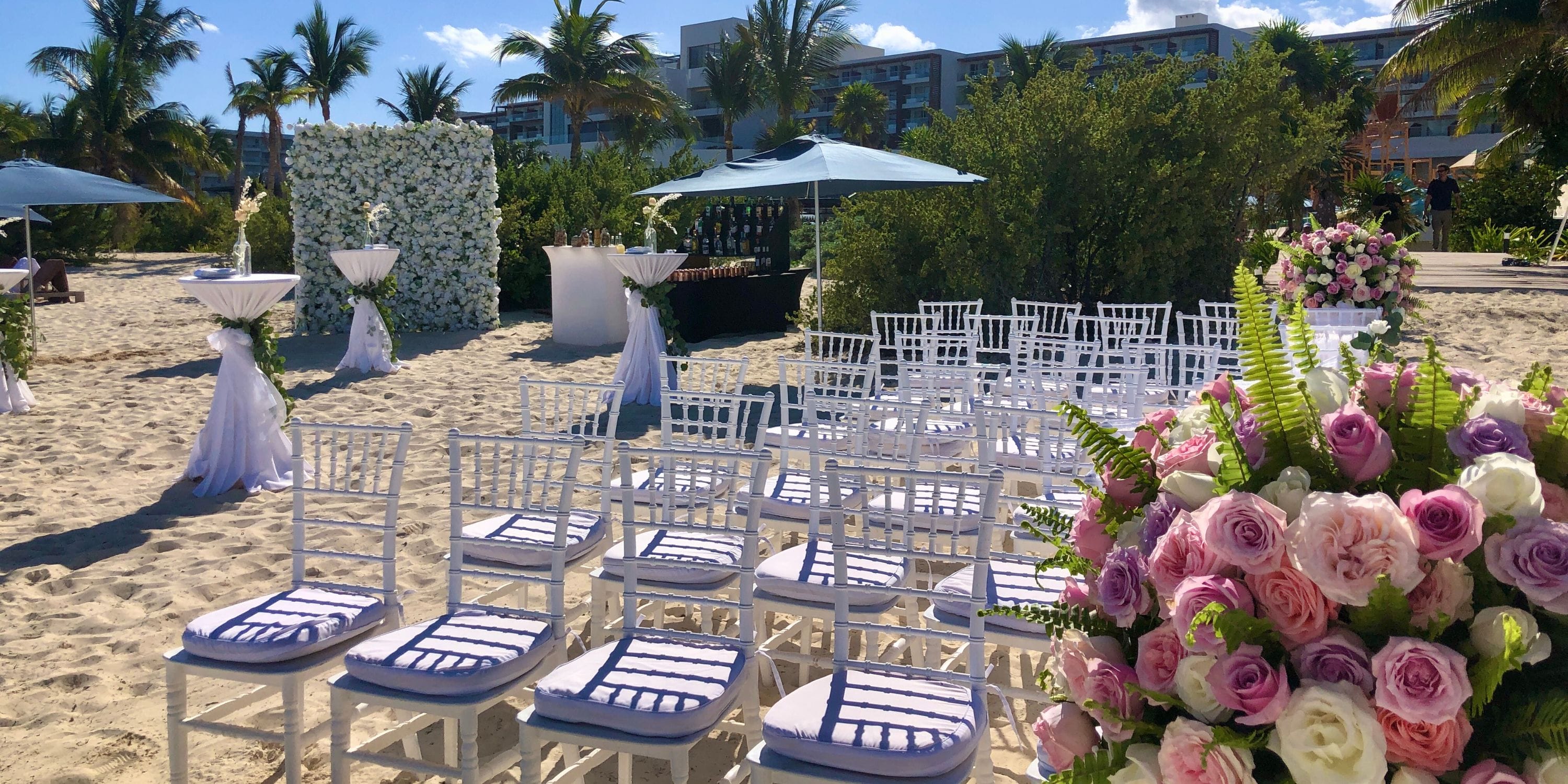 White chairs and floral arrangements prepared for a destination wedding at Royalton Splash Riviera Cancun.