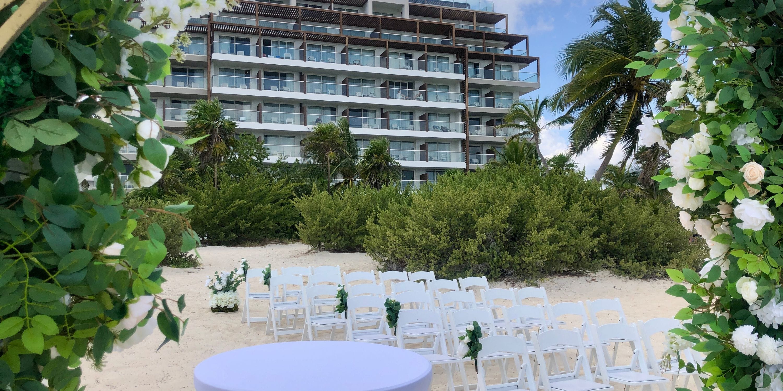White chairs arranged in rows for a destination wedding on the beach at Royalton Splash Riviera Cancun.