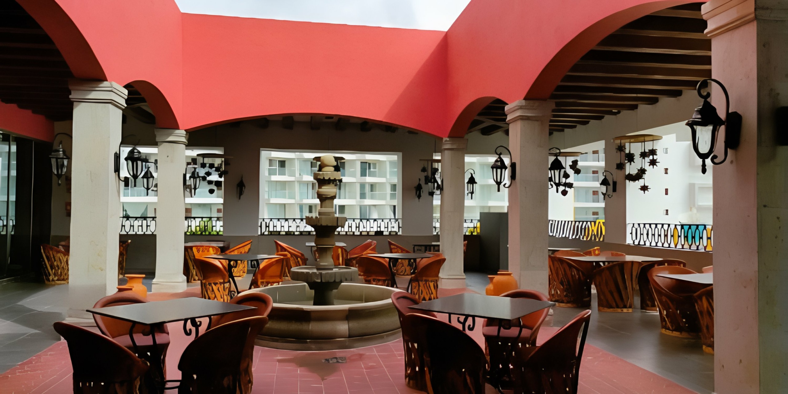 A restaurant with tables and chairs and the Royalton Splash Riviera Cancun.
