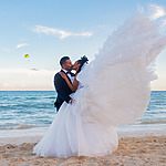 A bride and groom kissing on the beach, the best place to have a destination wedding.