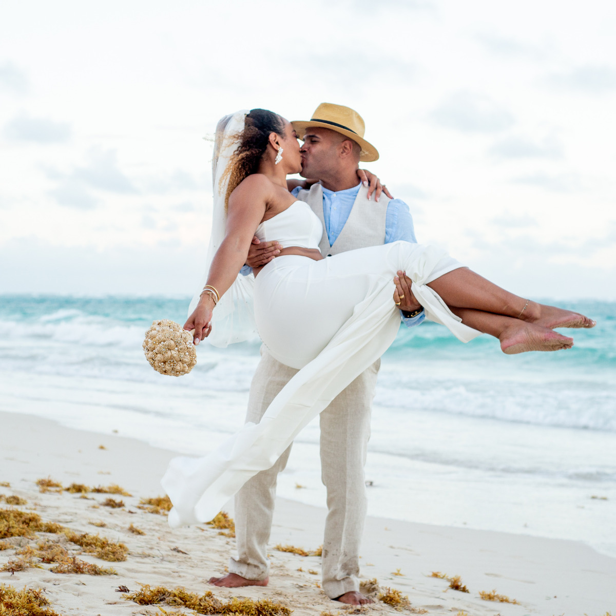 Couple kissing on the beach after their destination wedding, wondering what is the difference between destinations?