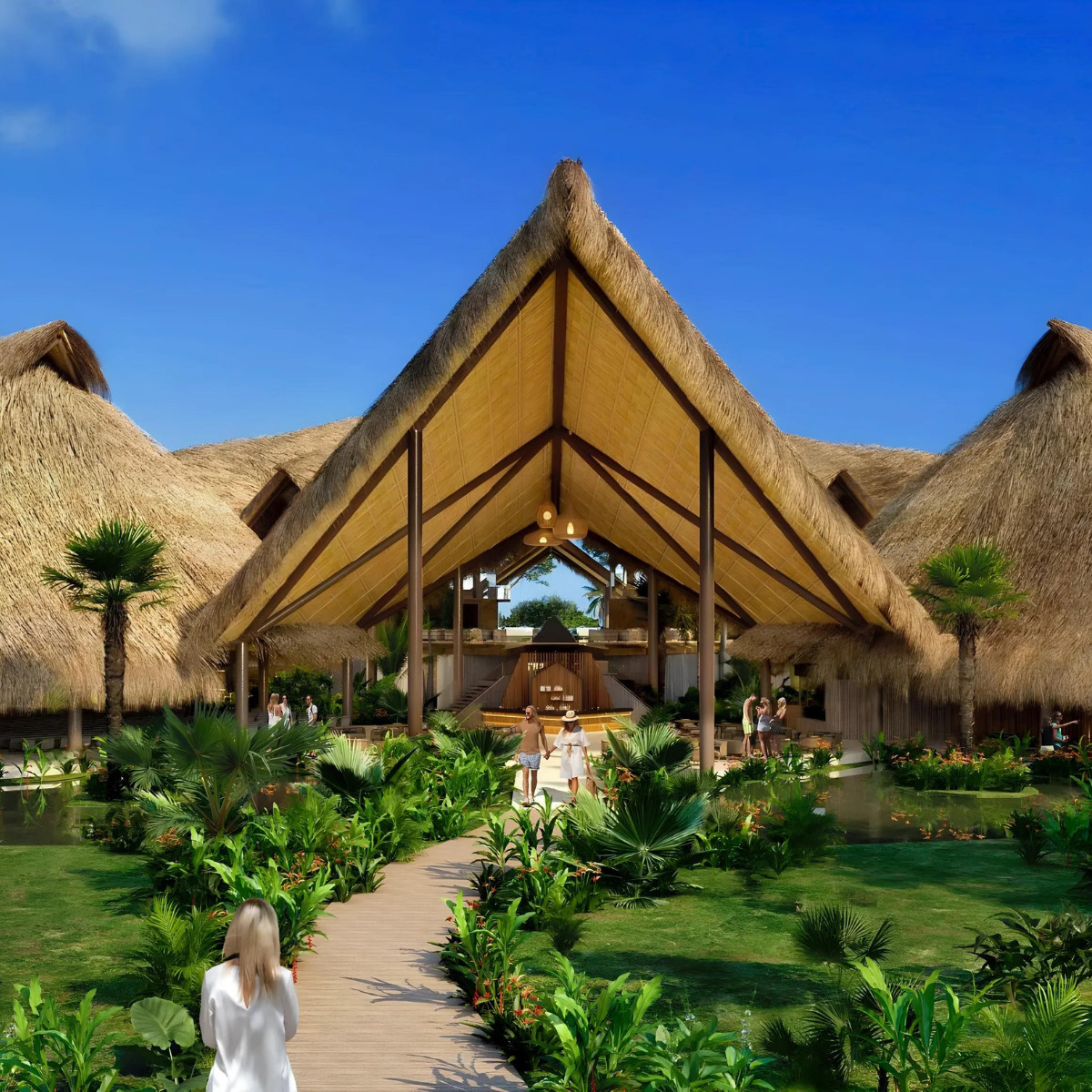 Open-air Dreams Flora restaurant, a perfect venue for destination weddings, with a large thatched roof, surrounded by lush greenery and a wooden pathway, with people walking towards the entrance.