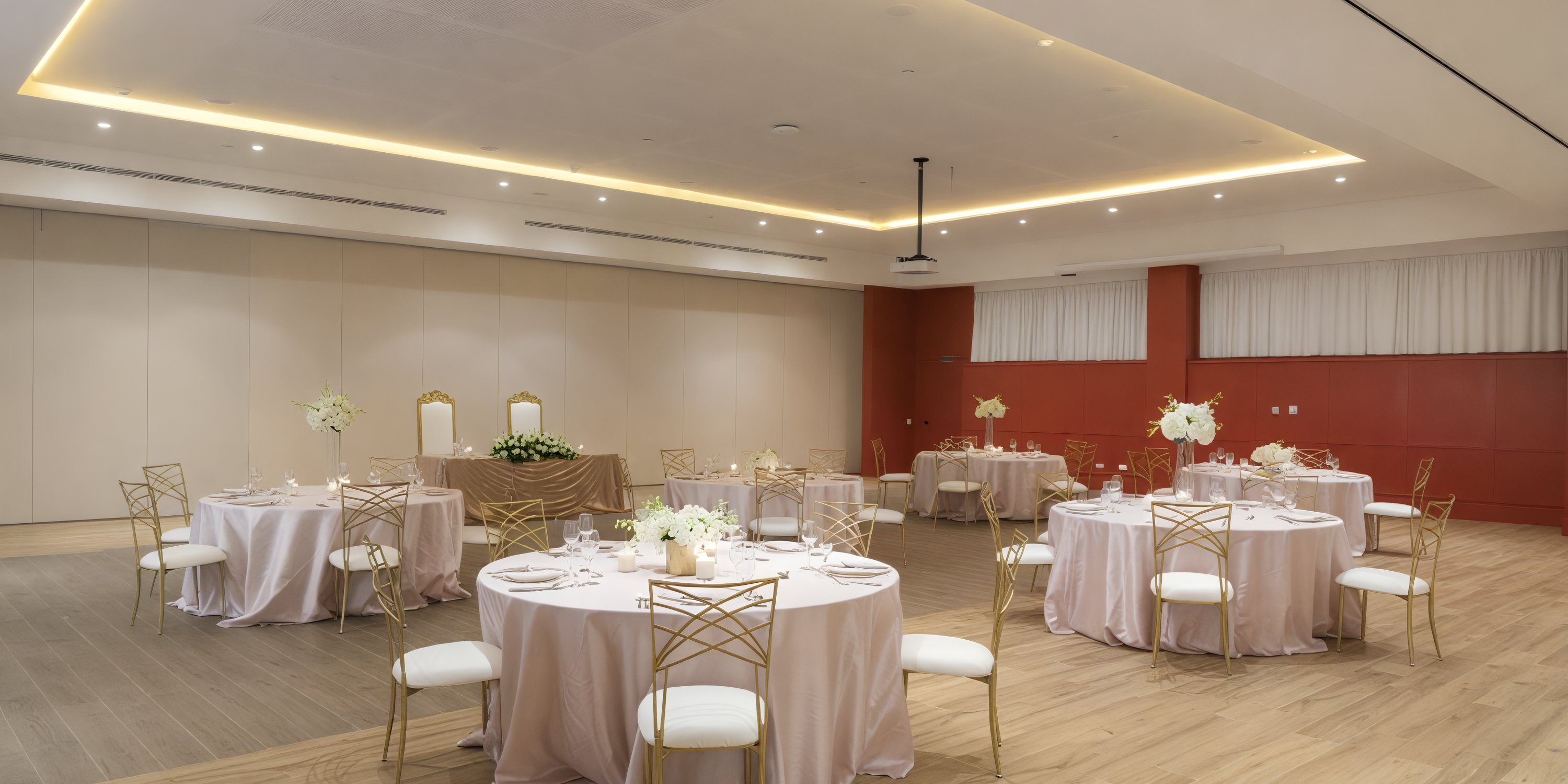 A stunning venue for a destination wedding, the Ocean Coral Spring banquet hall features round tables, elegant chairs, and exquisite floral centerpieces.