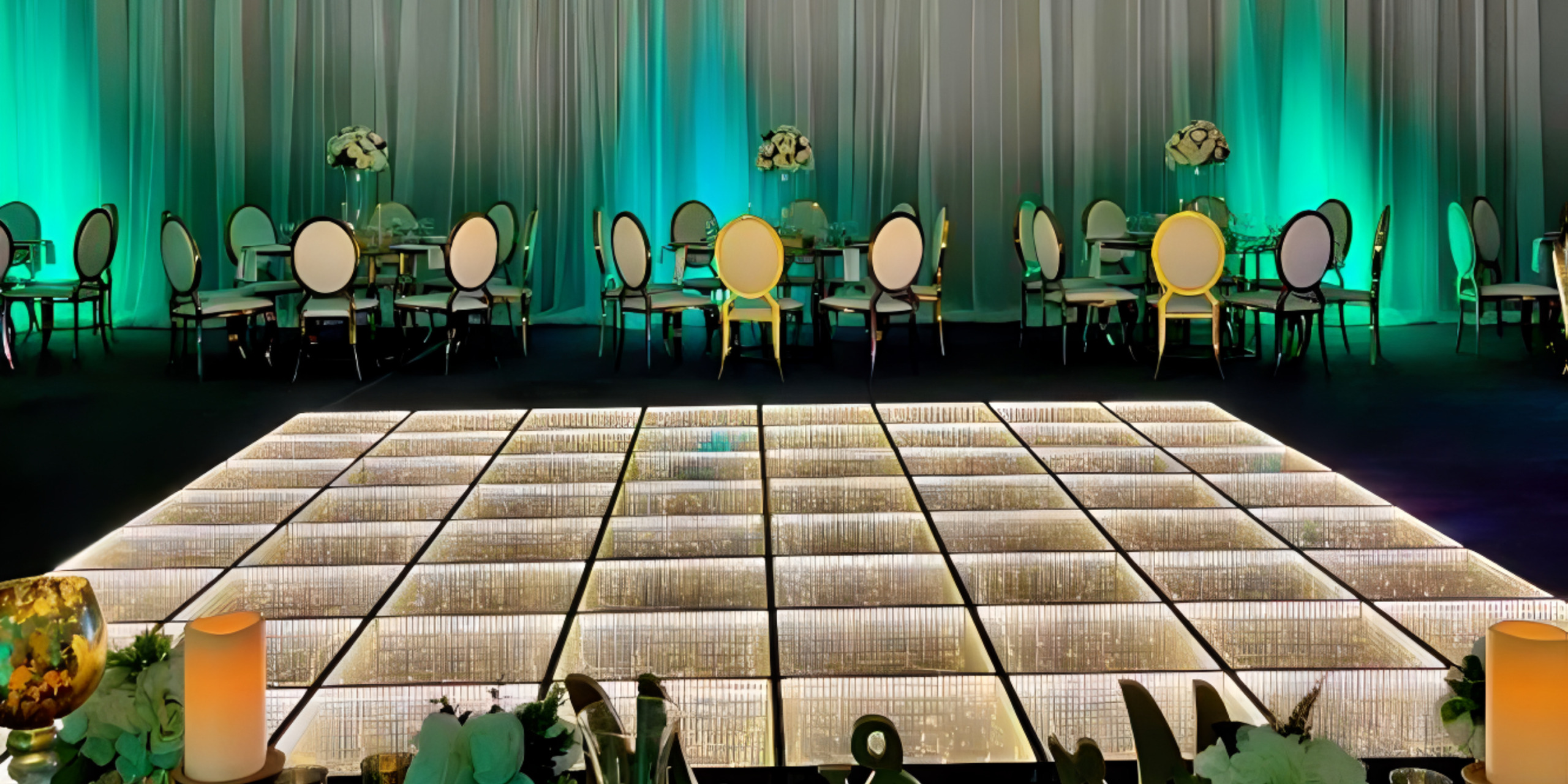 A large dance floor with green lighting, perfect for a destination wedding.