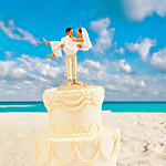 A wedding cake with a couple on top for a Mexico wedding.