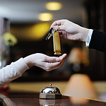 A person handing another person a key at a wedding.