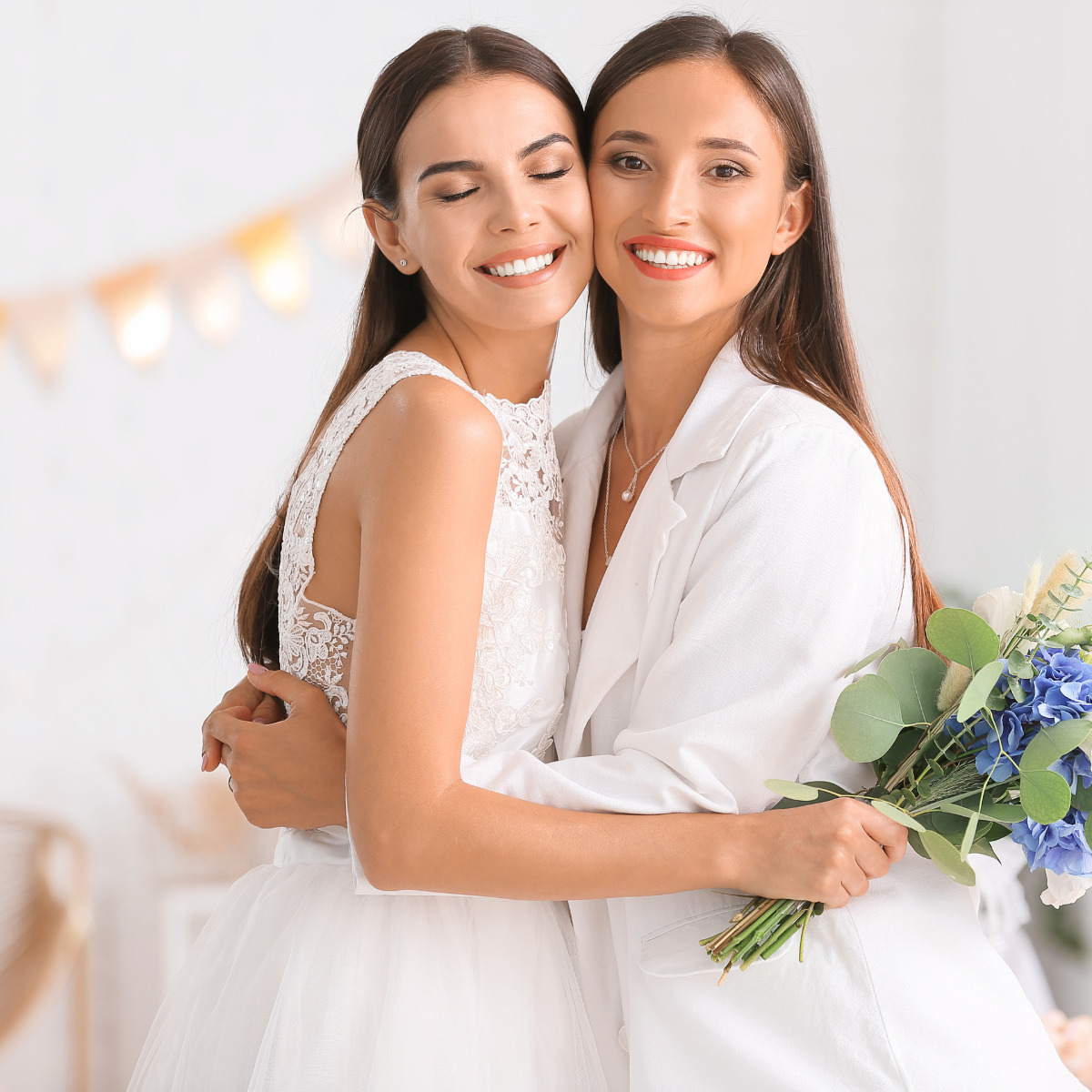 Two bridesmaids hugging each other at a wedding.