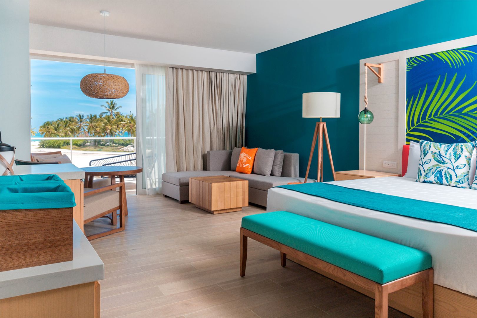 A room with Margaritaville Island Reserve Cap Cana Wave accents and a view of the ocean, perfect for a wedding.