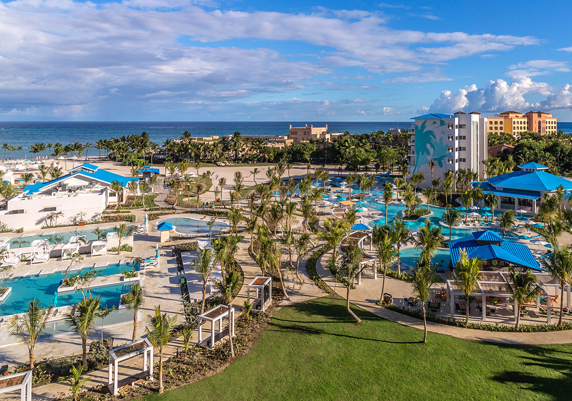 An aerial view of Margaritaville Island Reserve Cap Cana - Hammock with a pool, beach, and wedding setup.