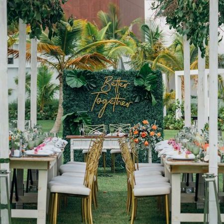 A wedding reception set up in a tropical garden.