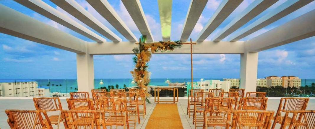 A wedding ceremony outdoors with Margaritaville Island Reserve Cap Cana - Hammock and a view of the ocean.