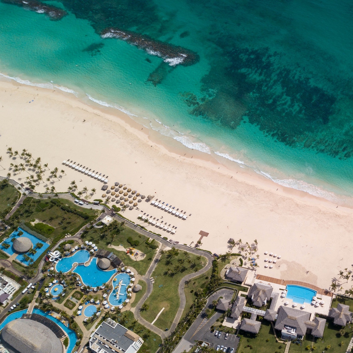 An aerial view of a beach and resort set up for a wedding.