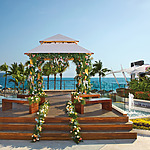 An affordable destination wedding package featuring a gazebo set up in front of the ocean.