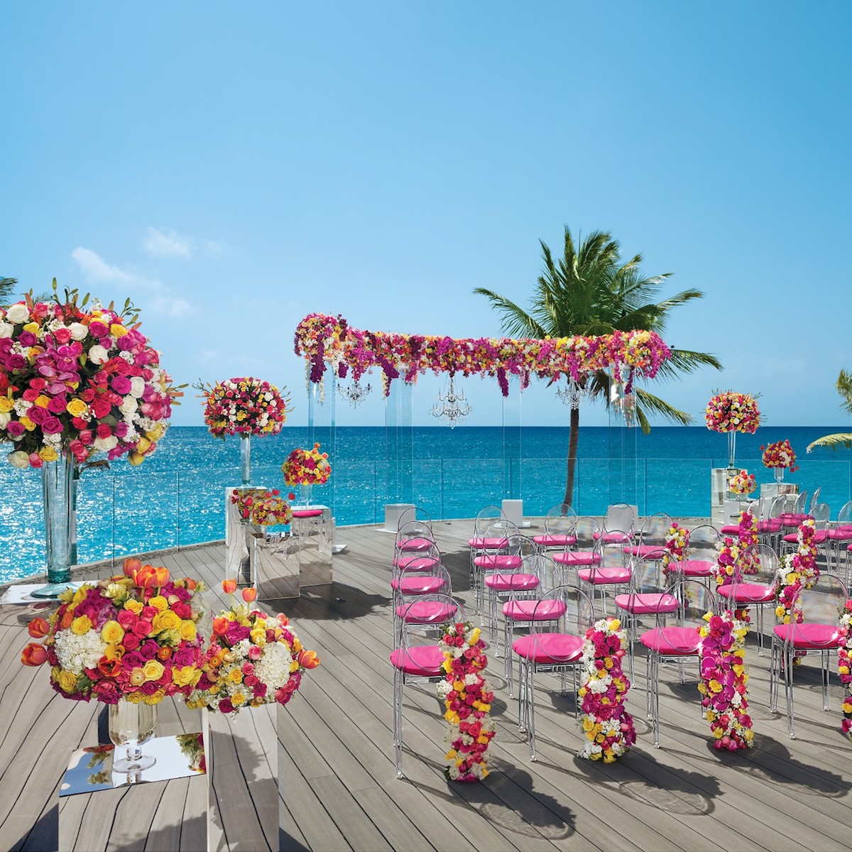 An all-inclusive wedding ceremony set up on a deck overlooking the ocean.