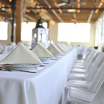A white table with white chairs, perfect for wedding packages for 200 guests.