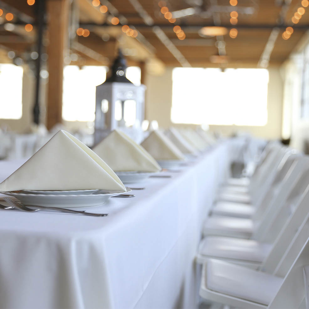 A white table with white chairs, perfect for wedding packages for 200 guests.
