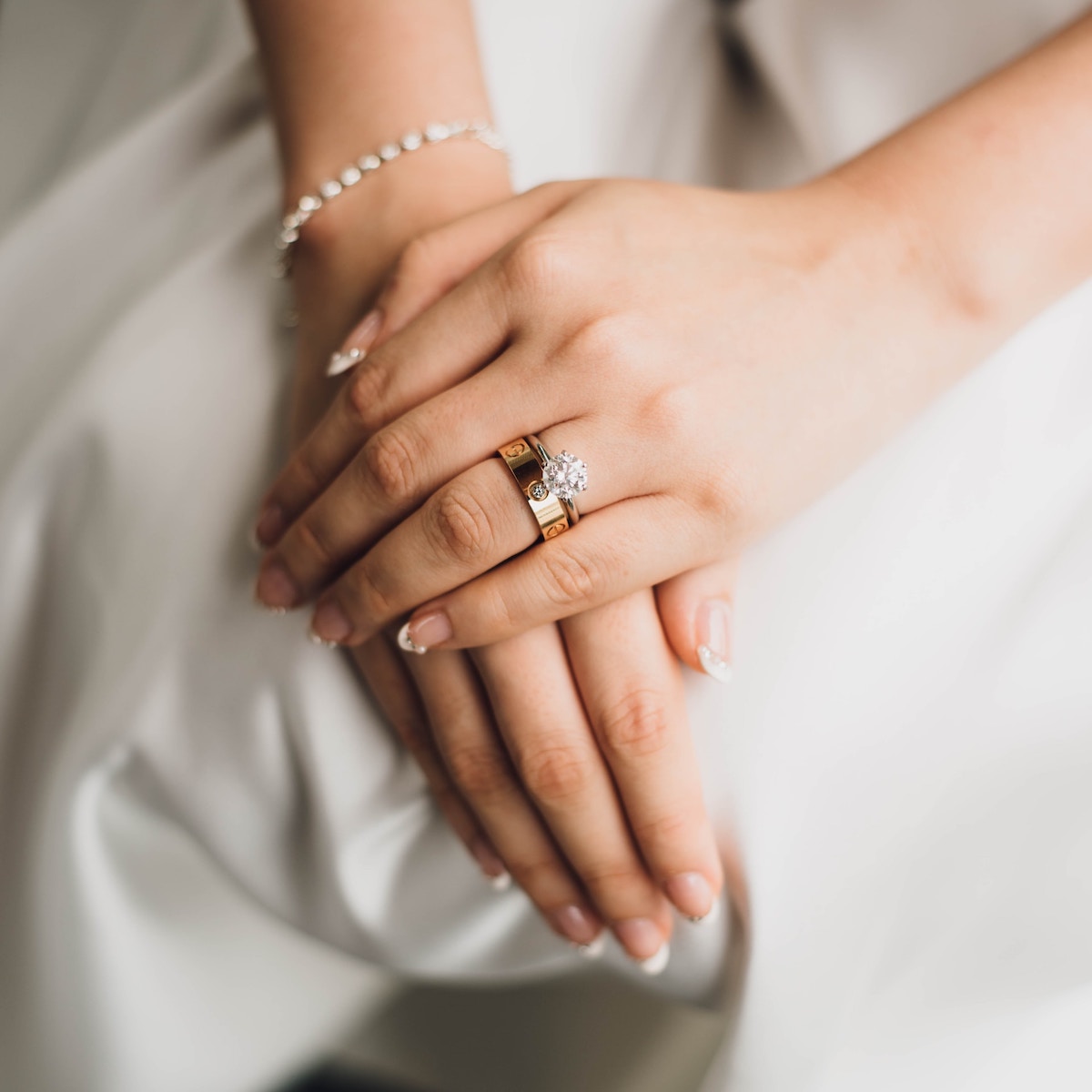 A bride's hands with a wedding ring on them.